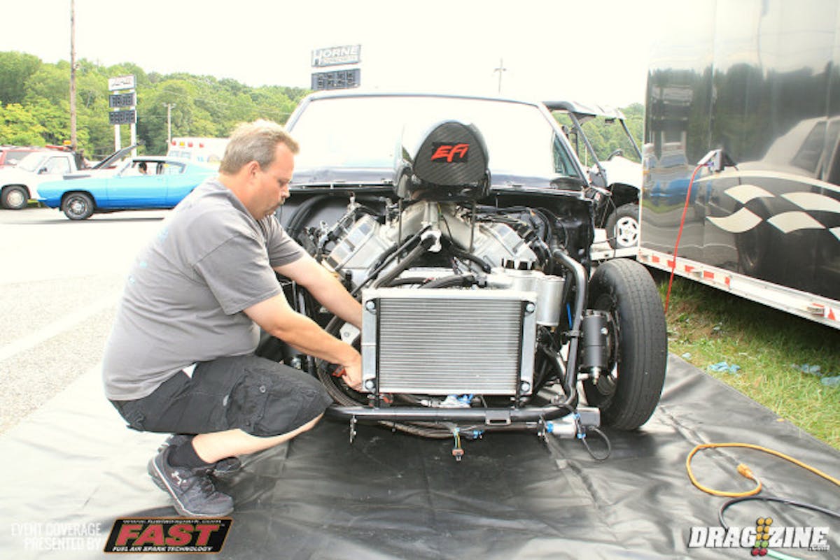 We dropped by Marc McCloud's pit this morning catching him oil the engine before start up. The track was a little tricky for the NA Ultra 275 cars.  He was able to get hooked up but had to pedal the car out of a wheel stand landing fifteenth on the sheet with a 5.07 at 137 MPH.