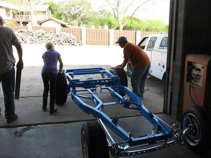 May 2011, the chassis is done and painted and we’re rolling the chassis out into the sun.