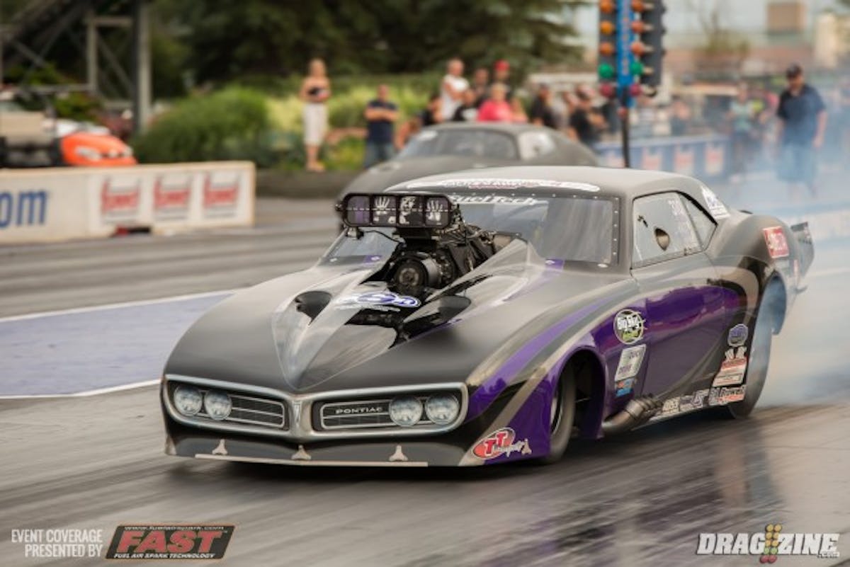 Melanie Salemi continues her march to the $40,000 purse in Outlaw Pro Mod with another close win in the semi-final round. Her 5.86 at 240mph defeated a hard charging Wes Goddard’s 5.87 252 mph pass.