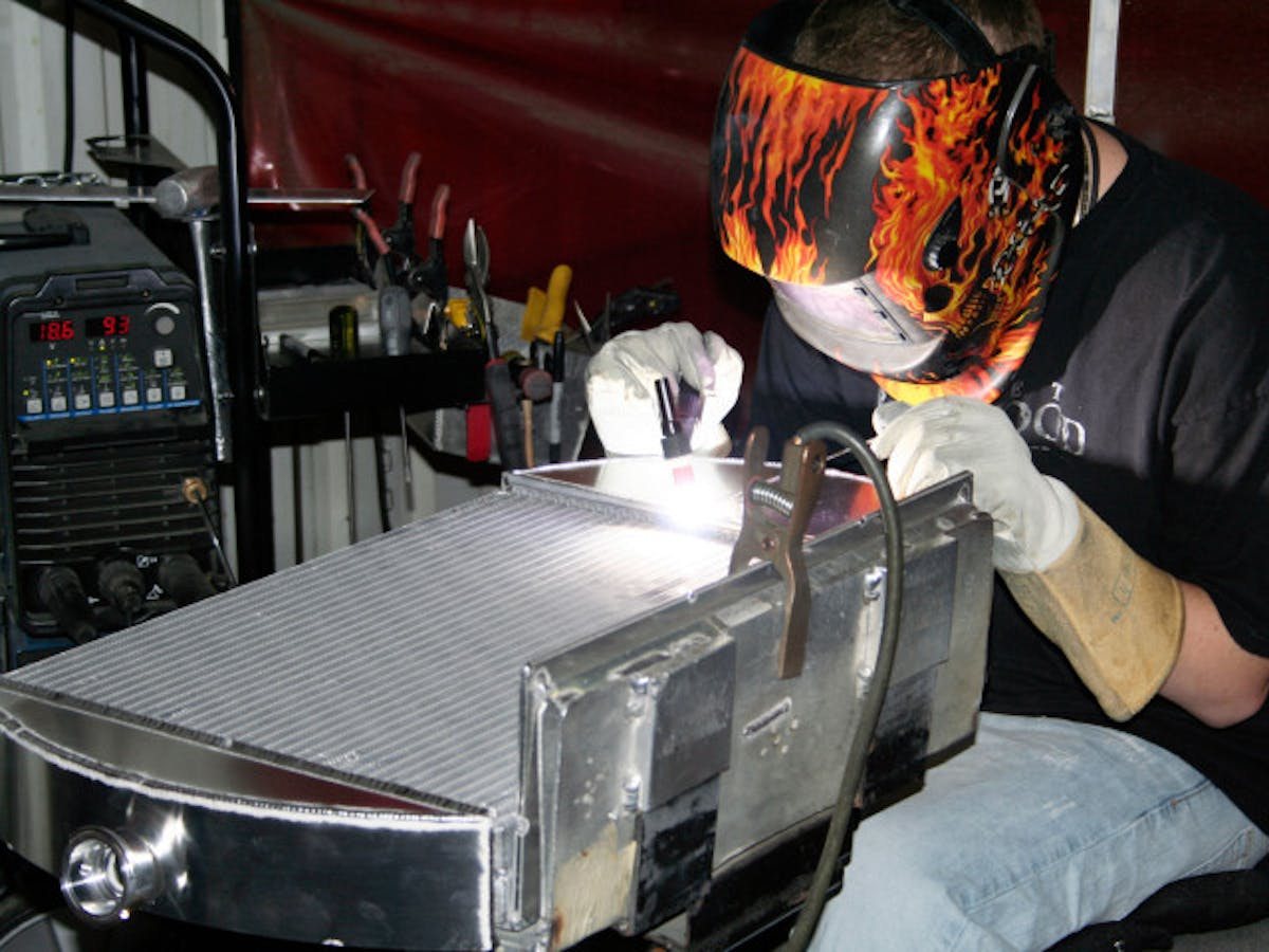 One of AFCO's fabricators putting the finishing touches on a custom radiator. Offering custom builds eliminates the need for customers to modify radiators for their specific, and often unique, build.