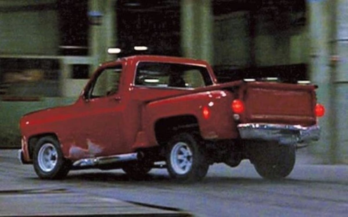 The chase inside a warehouse, with the Driver in the Chevy C10.