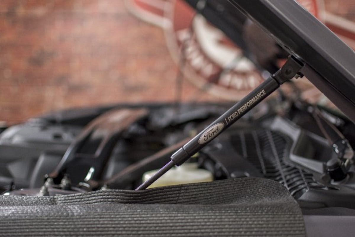 CJ Pony Parts didn’t just upgrade the performance lurking under its hood, the company also made the engine more presentable by ditching the prop rod with some Ford Performance hood struts. Once the hood is up, the engine looks better thanks to an Anderson Composites engine cover, a Scott Drake fuse box cover and a JLT performance master cylinder cover.(Photo Credit: CJ Pony Parts)