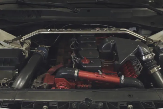 The 5.9L Cummin fit inside the engine bay fairly well. Modifications to the chassis had to be made, however, so the firewall and hood did not have to be. 