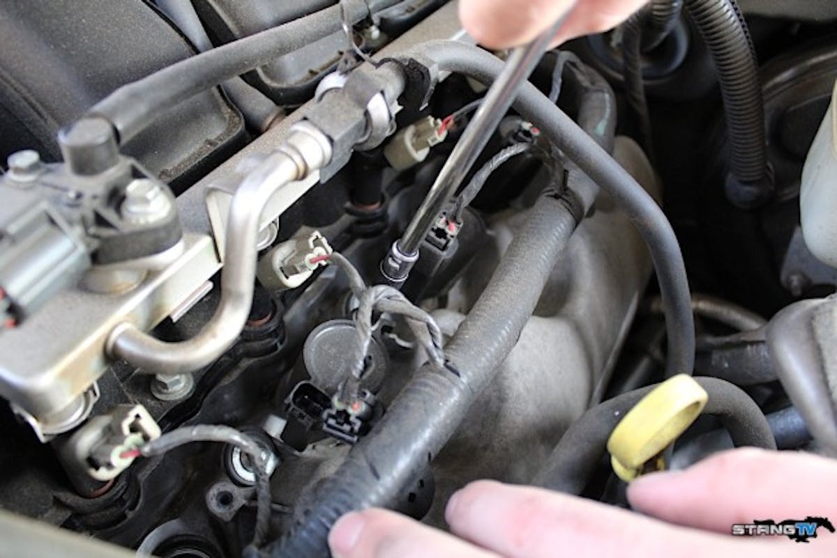 We started the process by removing the factory coil plugs.