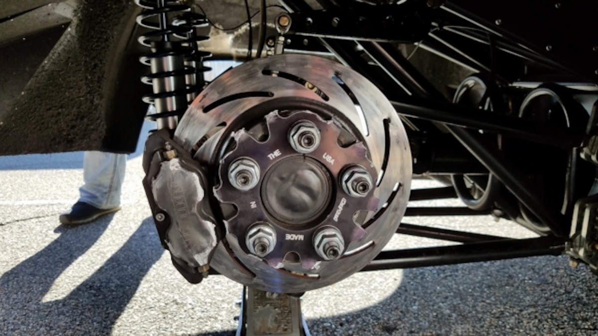 The wheel center remained bolted to the hub while the spokes broke and sent the wheel barrel and tire exiting the car on test run.