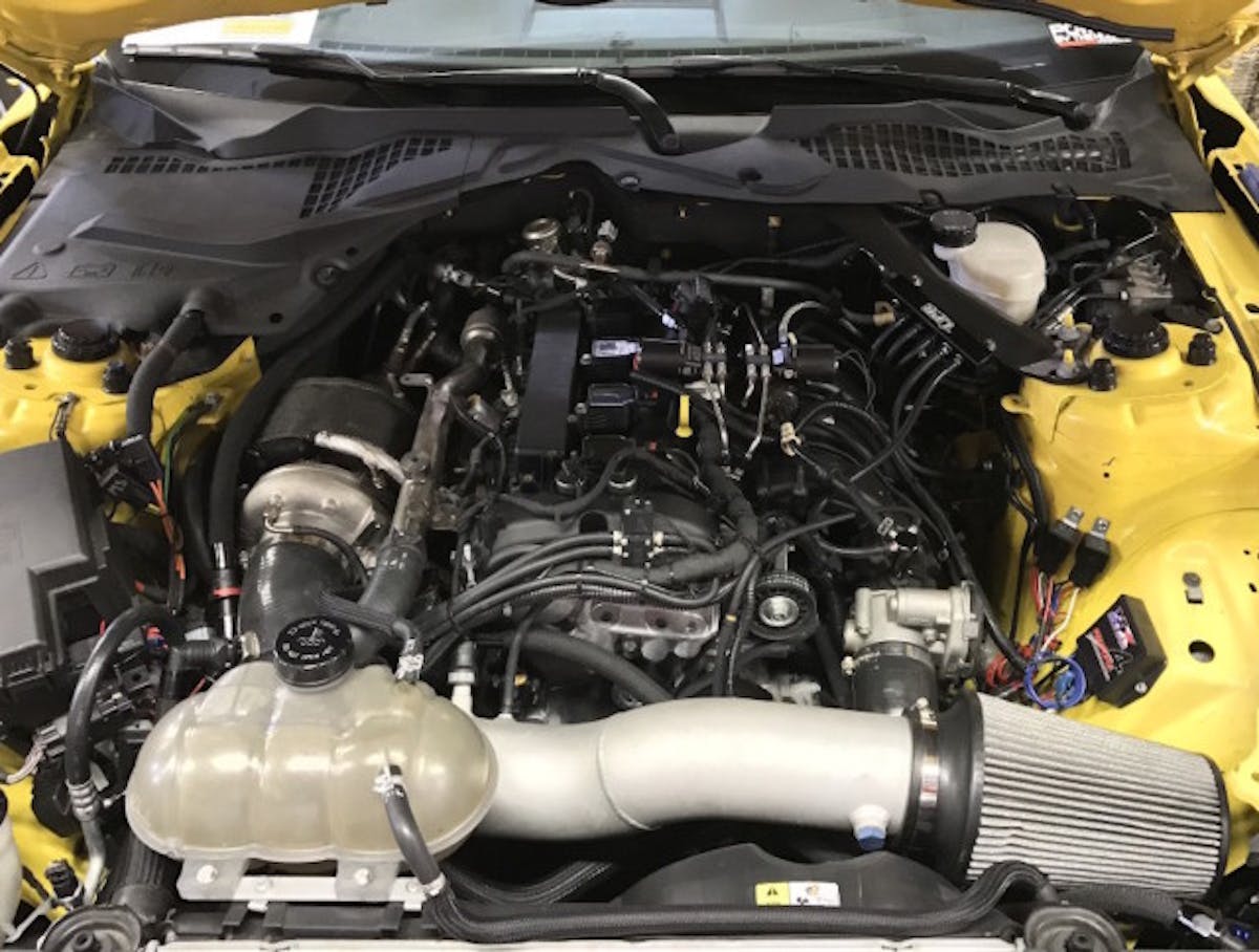 The foundation of the UPR EcoBoost Mustang is a robust short-block constructed by MPR Racing Engines. It is boosted by a cp-e Atmosphere turbo kit and sprayed by a Nitrous Express nitrous/methanol system engaged by an NX Maximizer 4 progressive controller. A cp-e fuel bar supplements the direct-injection system with four port injectors deliver E85. (Photo Credit: Steve Gelles/UPR)