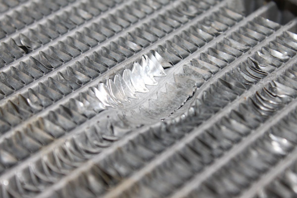 An example of bent fins on a radiator. While some bent fins are to be expected from normal wear and tear and handling, any area more than 3-4 in diameter presents a significant cause for replacement of the radiator.