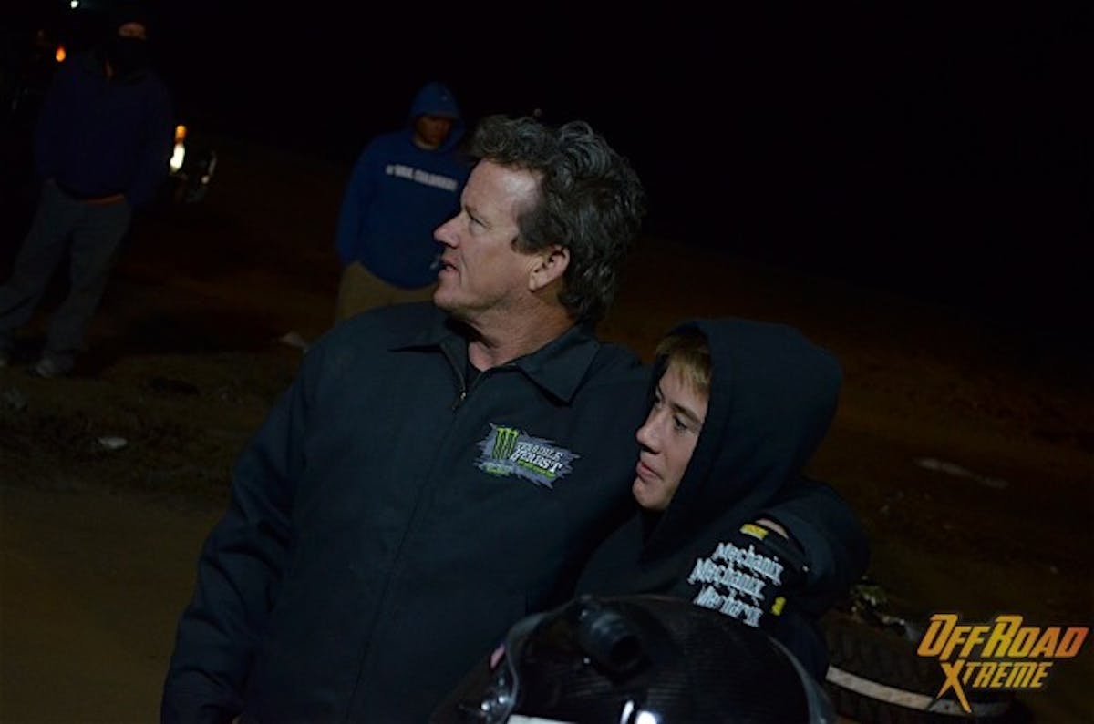 Tim Herbst (left) and his son Pierce sitting at the pit waiting for Tim to jump in the no. 19 truck.