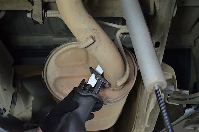 Out with the old. Cut the tailpipe from the back of the muffler to make removal much easier.