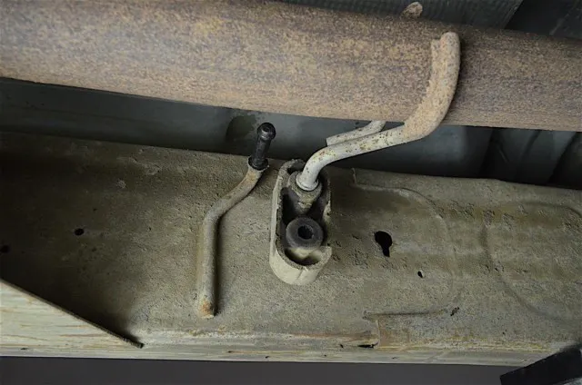 The rubber isolators get reused with the new system. A pry bar and lubricant makes removal easy. 