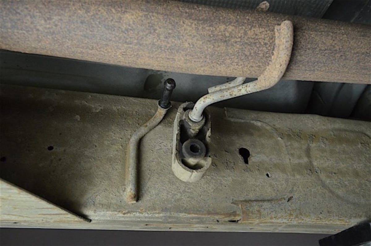 The rubber isolators get reused with the new system. A pry bar and lubricant makes removal easy.