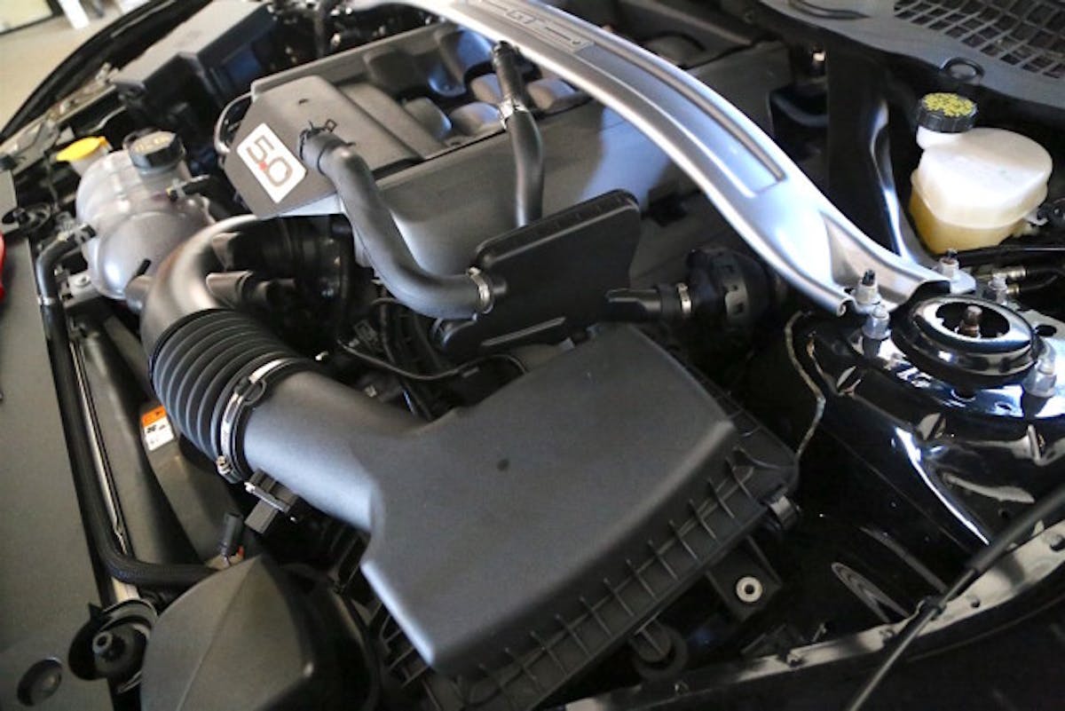 Coastal’s master tech Steven Harris gets down to business by disconnecting the factory Induction Sound Tube, which pipe inlet sounds into the cabin. The factory system must meet a number of standards, including how loud it is, so the IST is a way to connect the driver with the engine sounds. The JLT system is compatible with the IST, but it also supports deleting it with plugs as well.