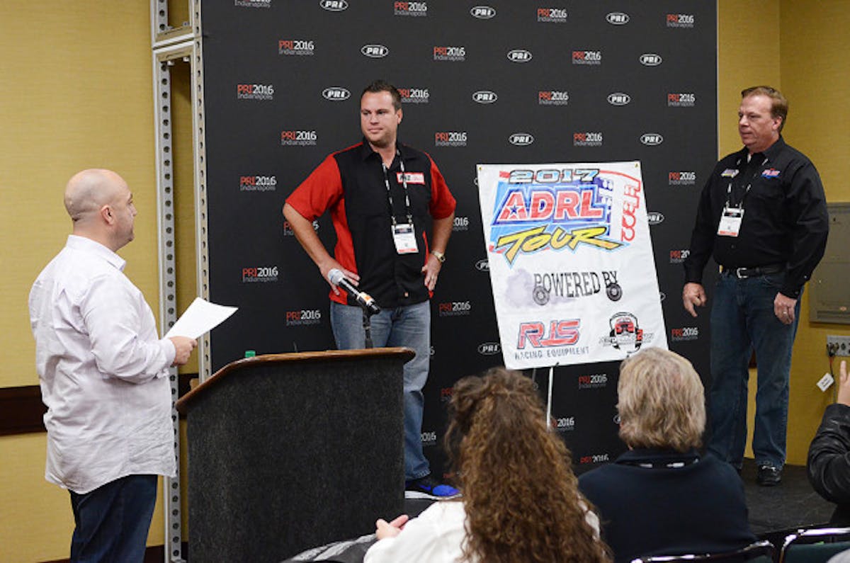 Seatbelt Solutions CEO Jeff Biegun (right) with son, Ryan (center) at the PRI Show in Indianapolis.