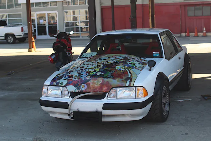 In a sea of Focus and Fiesta STs, this JDM-inspired Fox Mustang with its exposed oil cooler really stood out to us in the parking lot. It was unique to say the least!
