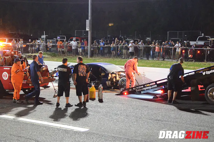 Father and son survey the damage to Terry Barkley's Camaro after a high-speed accident in St. Louis. Carl, Jr. has shattered the 1/8-mile Pro Extreme record in the very same car with a clocking of 231 mph.