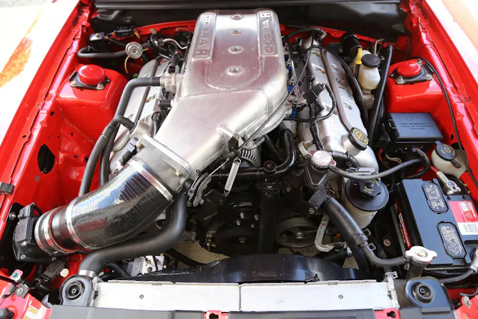 Paul upgraded his rare R-model with a nice selection of prototype Ford parts and a few choice aftermarket pieces. As you can see here, it features a prototype intake with a larger plenum and freer flowing inlet fed by a larger 90mm mass air sensor in front of the factory 80mm oval throttle body. This R-model came to Paul with a blown engine, so it took him a while to assemble the new combination that he wanted to put it back on the road. The centerpiece was a fresh 5.4-liter engine that is actually a Cobra R prototype engine built at Ford’s Engine Manufacturing Development Operations facility.