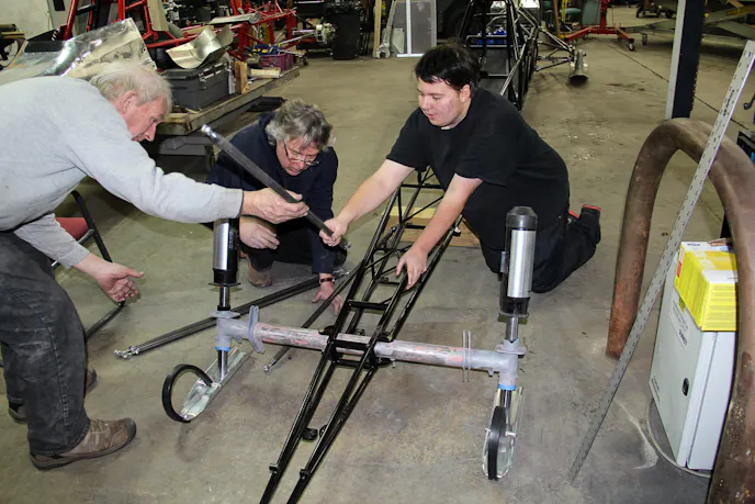 Byron Nelson (left), Anderson (center) and Buddy Michaelson work on assembly of the Arctic Arrow in Anderson's Minnesota shop.