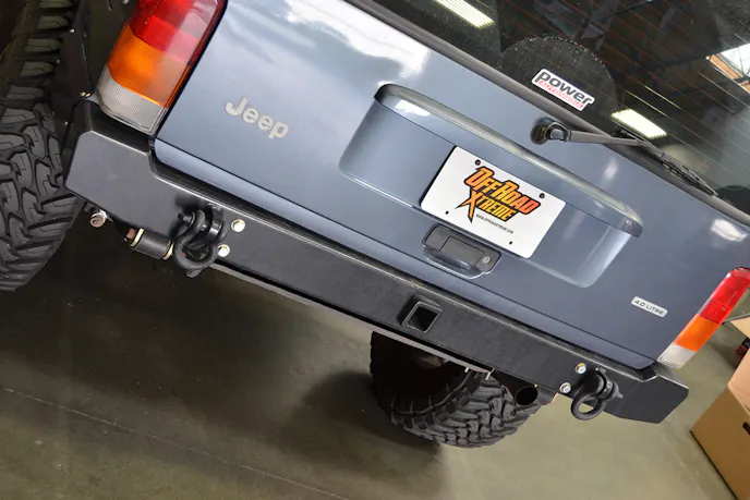 Project XtremeJ received a nice heavy duty bumper but needed a way to get the spare tire out of the cargo space.