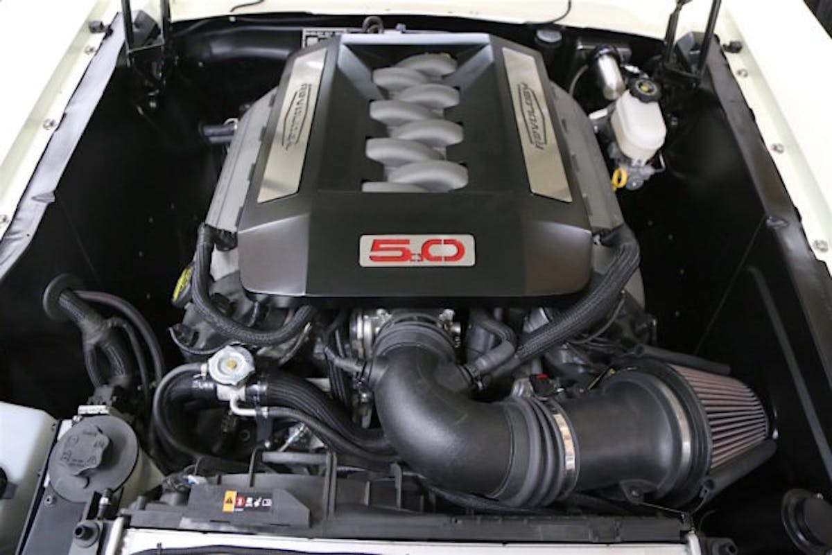 Bringing the kind of performance and driveability you can only get from a modern engine is a Ford Performance Coyote crate engine under the hood. It is nestled in the engine compartment with a combination of aftermarket parts built to Revology specs.