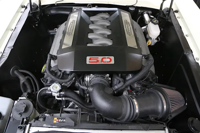 Bringing the kind of performance and driveability you can only get from a modern engine is a Ford Performance Coyote crate engine under the hood. It is nestled in the engine compartment with a combination of aftermarket parts built to Revology specs.