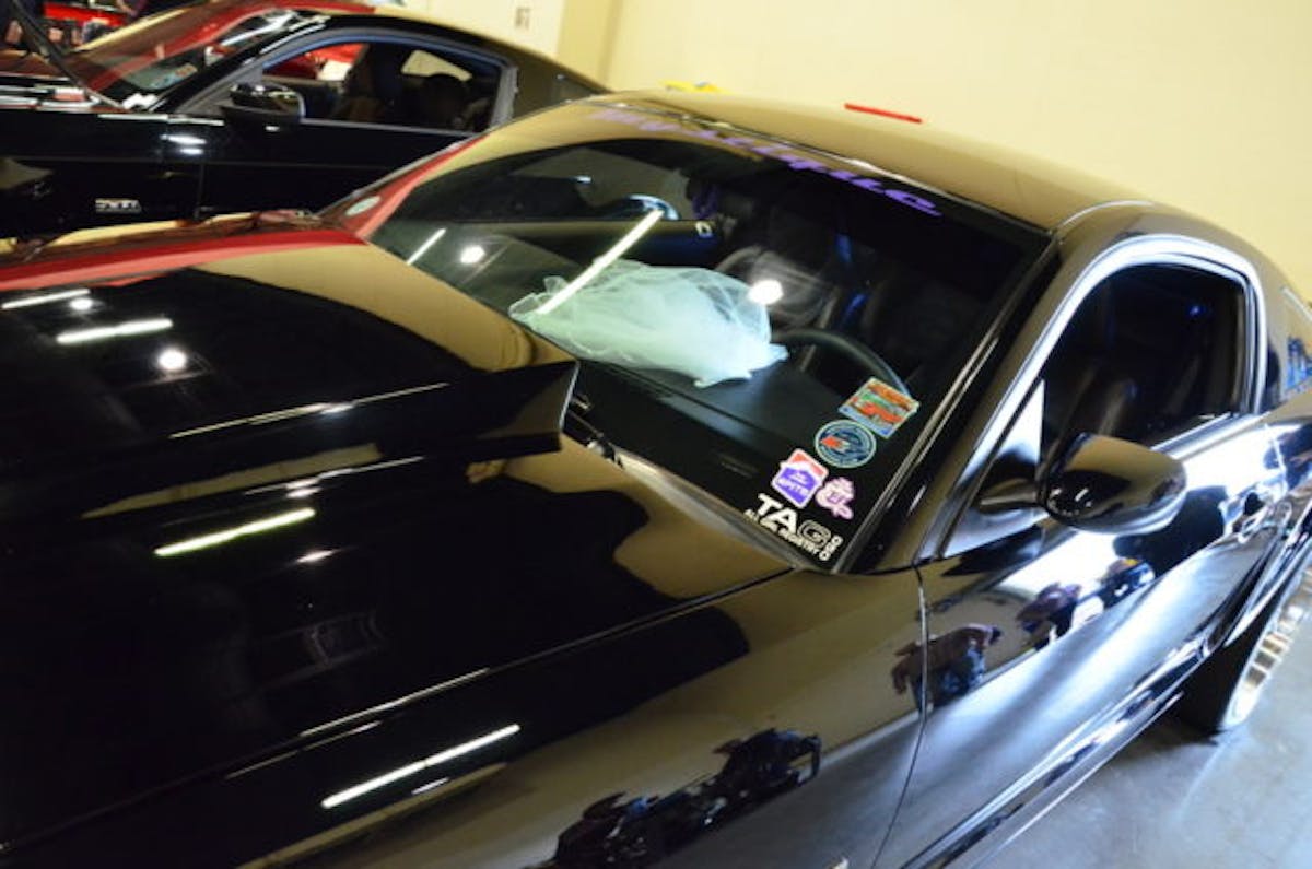 Yeah, that's a wedding dress, but no, it's not a black Trans Am! It is a black Mustang though, Rick & Susan Ball chose the event to host their very unique and super cool Mustang Wedding!