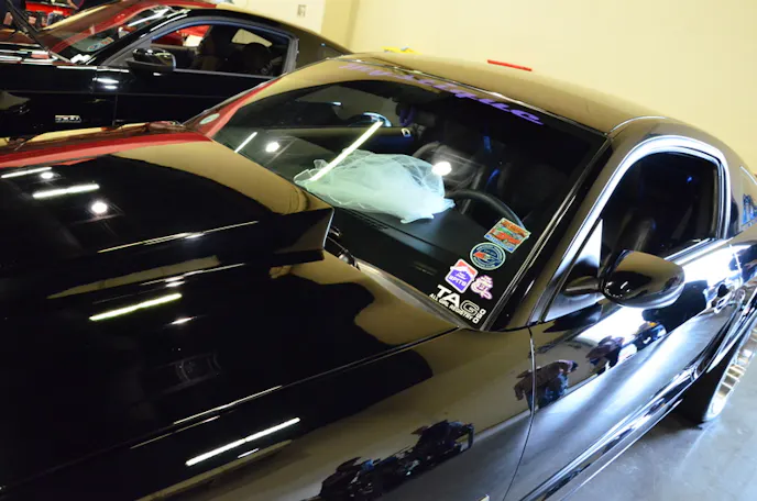 Yeah, that's a wedding dress, but no, it's not a black Trans Am! It is a black Mustang though, Rick & Susan Ball chose the event to host their very unique and super cool Mustang Wedding!