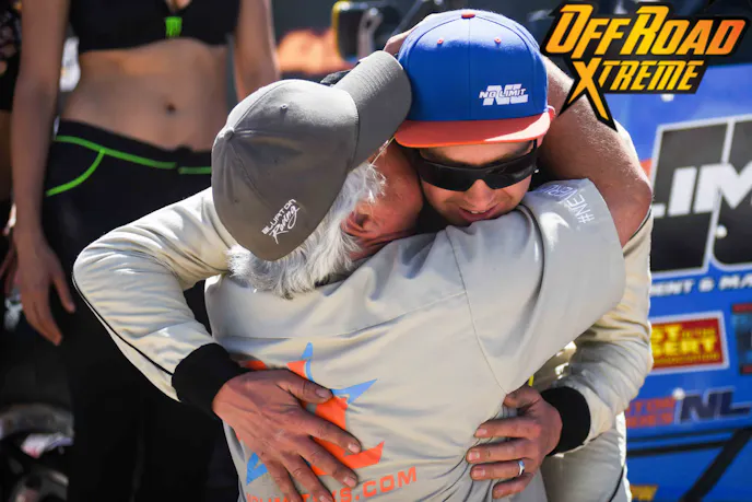 Phil Blurton is congratulated by his father on the podium after upon winning the UTV World Championship Overall.