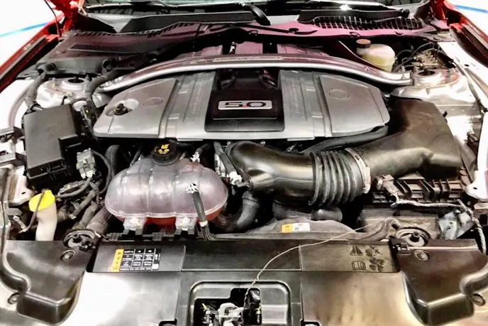 While Ford designers put a lot of effort into accenting the first-gen Coyote engine, the new dual-fuel version is completely shrouded by a monolithic engine cover.