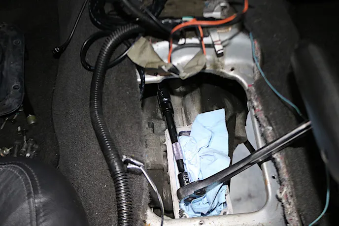 We accessed the final two transmission bolts from inside the car with some long extensions. 