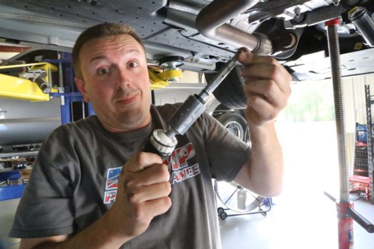 If you want to remove the shifter without dropping the driveshaft, you’ll need to remove the 10mm fasteners and retaining ring and remove the shift lever. With this out of the way, you can snake the rest of the shifter mechanism up and out through the hole in the transmission tunnel. Then you can lower the car and remove the last traces of the imprecise factory shifter.