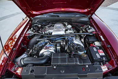 A built 4.6-liter engine boosted by a ProCharger P-1SC supercharger powers the Red Racer.