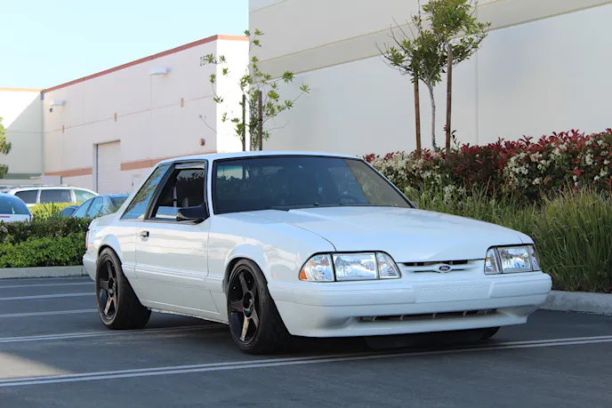 When this '92 LX rolled off the assembly line it was packing 225 horsepower. While the factory braking system provides adequate stopping power for a stock example of this vintage, this particular Fox body's 5.0 has been upgraded significantly, and the addition of a Vortech supercharger into the mix means that it's capable of reaching high speeds in significantly less distance than it could from the factory, and that in turn means a lot more work for the braking system. In order to maintain balanced capability, the brakes need to be every bit as capable at their task as any other performance component.