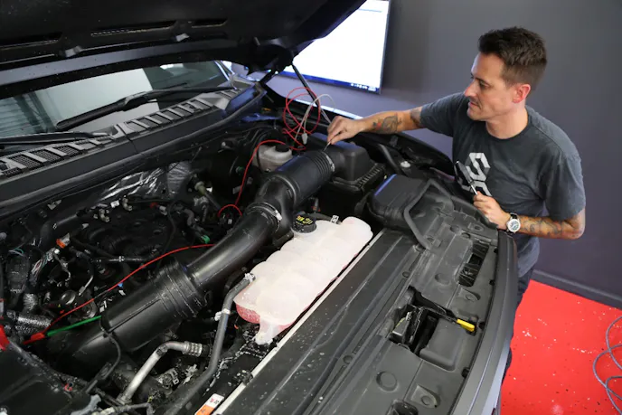 Jonas Cooper, Chief Technology officer at Lethal Performance, starts the installation by removing the factory airbox lid and induction tube. At this point, you will also want to R&R the stock spark plugs and gap them down to .025-inch.