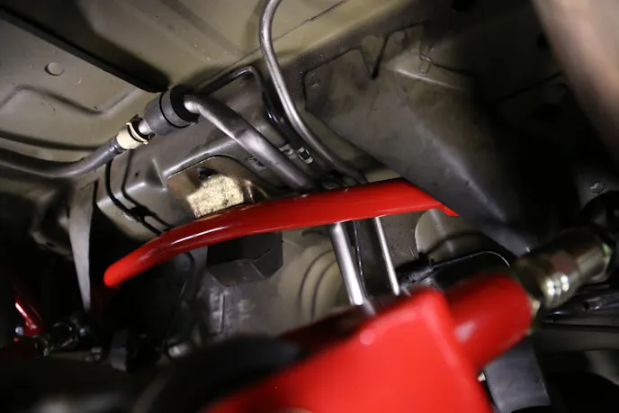 Next he installed the cross brace, which connects the inner side of the two control arm mounts, and bolted up the upper control arms, whose bolts connect the two torque box braces. “It disperses the load from the outer bolt to the frame rail and then the inners tie together,” Tommy Stone of BMR explained. “So it stiffens everything up that way.”