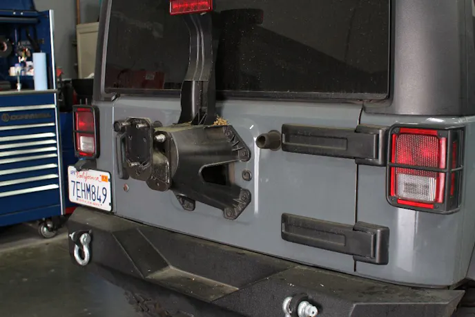 The factory spare tire carrier serves the purpose fora factory vehicle. It is not built to survive the off-road lifestyle with a larger tire on it.