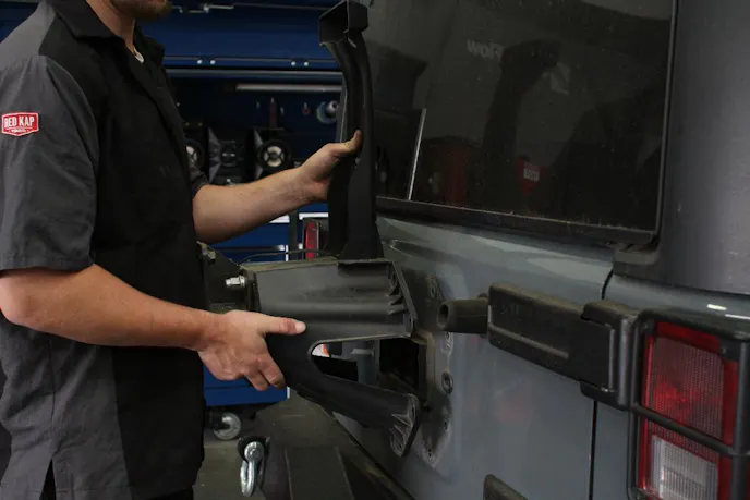 Unbolt the factory tire carrier and set it aside.