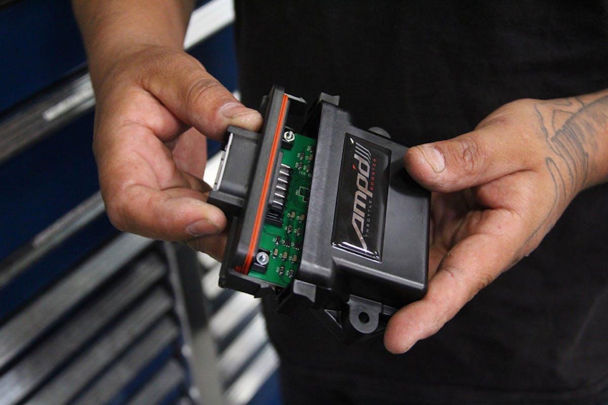 image shows AMP'd Throttle Booster being opened to access sensitivity adjustment 