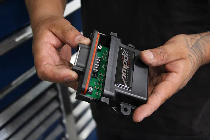 image shows AMP'd Throttle Booster being opened to access sensitivity adjustment 