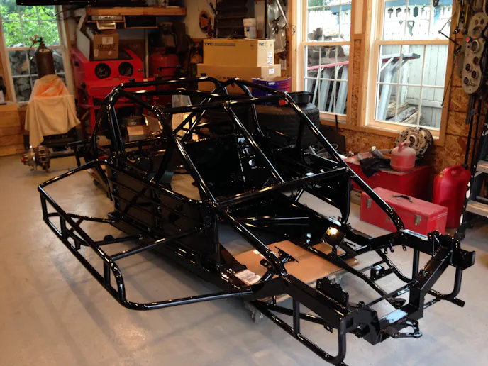 A freshly powder coated Nascar Modified chassis arrives back in Richard's garage