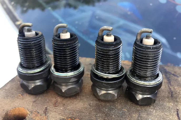 oil on spark plug threads