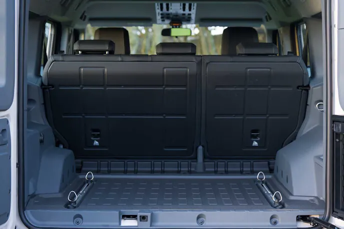The rear cargo area is boxy, deep, and has integrated L-tracks to easily secure luggage. Photo: INEOS Automotive