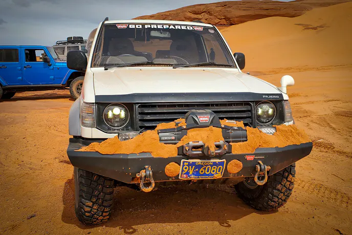 A surprise drop-off lead to steep incline, putting the Pajero nose-first into the sand. Photo by Andy Lilienthal