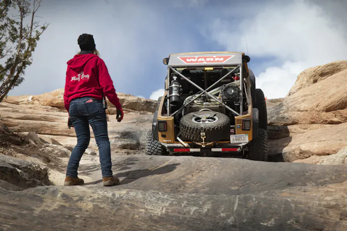 Goldie Rocks climbing up Wipeout Hill, with spotter Nena Barlow ready to help.