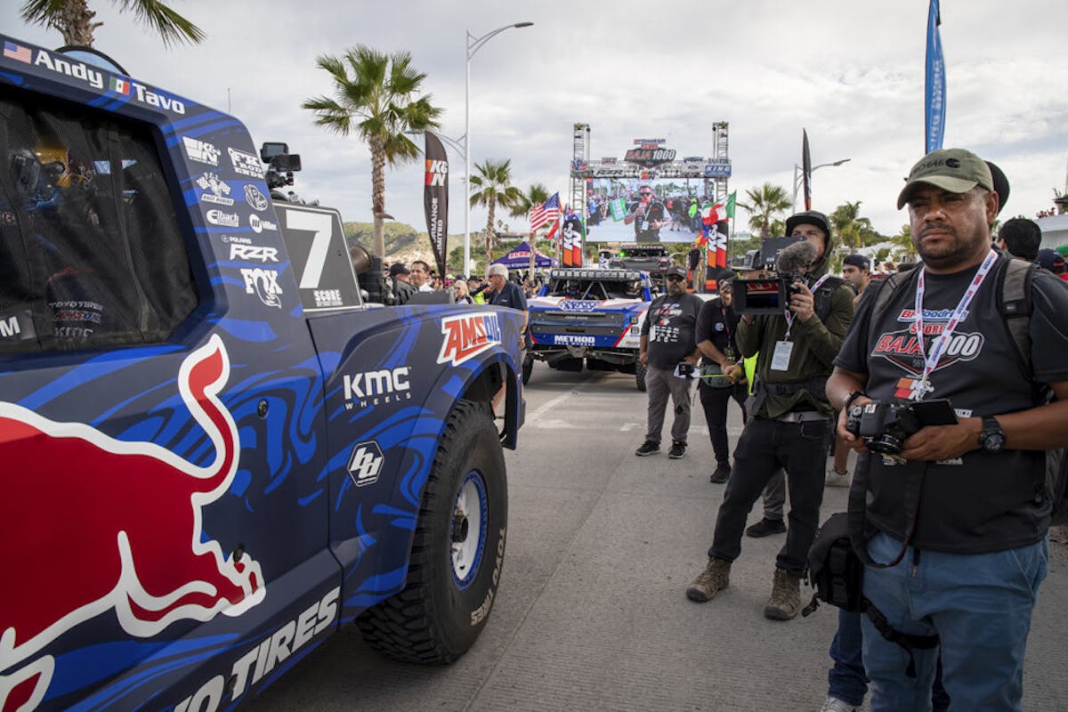 Trophy truck teams wait at the start line after their interviews finished. 