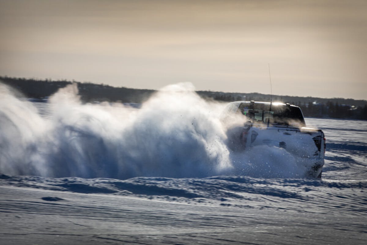 Ford Raptor with huge snow cloud while racing on Great Slave Lake during 2024 Alcan 5000 Rally