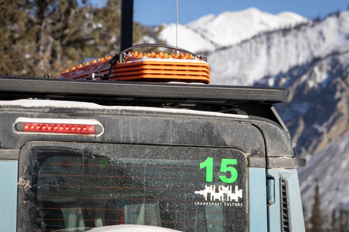 Rhino-Rack Pioneer platform rack housing a double jerry can holder and four MAXTRAX recovery boards.