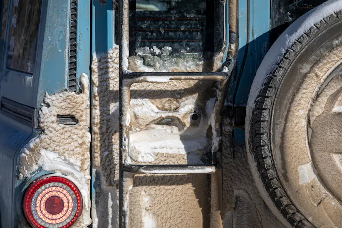 Snow piling up by the rear door handle.