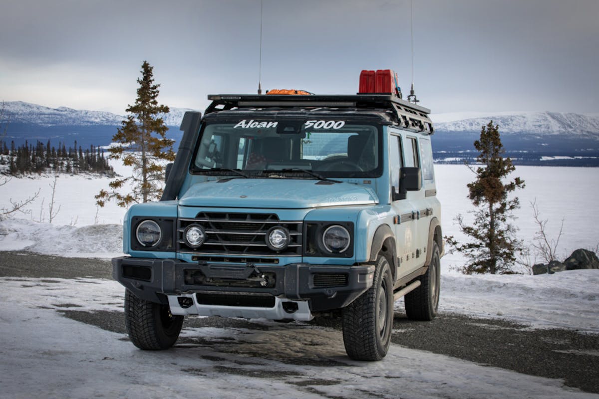 INEOS Grenadier front three quarters sits in front of a frozen waterway in Alaska
