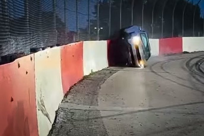 Chevy Camaro SS hits the wall hard and get's stuck on it's side.