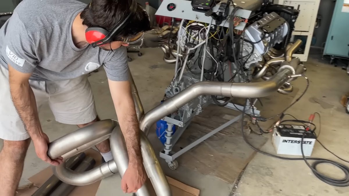 man testing the exhaust of their project car